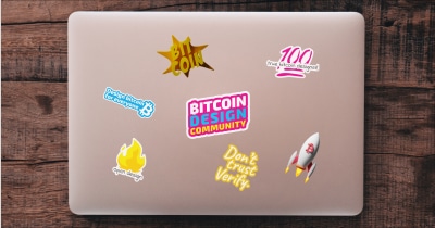 A laptop with bitcoin design stickers on it